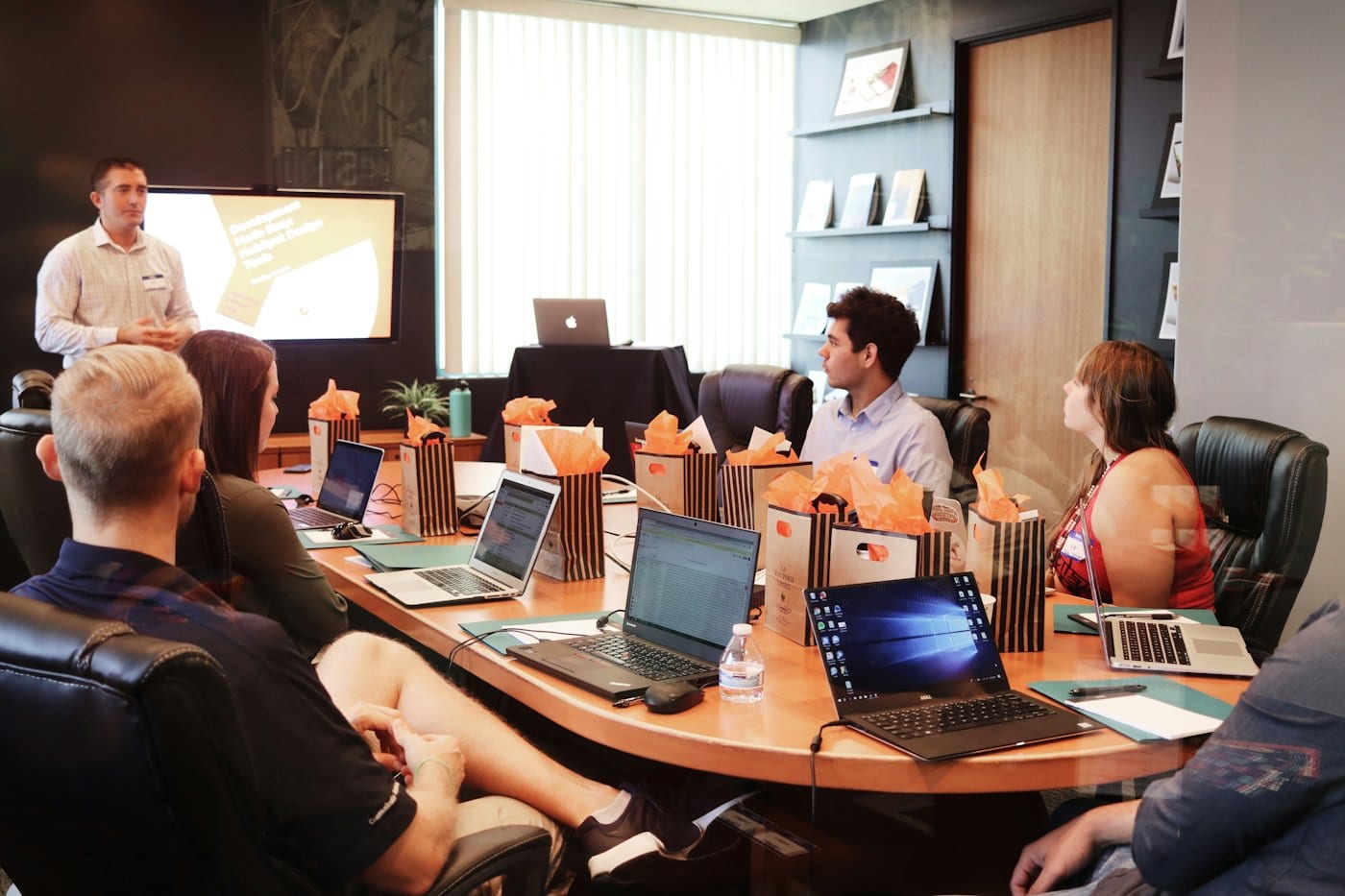 Participants with laptops in a training room